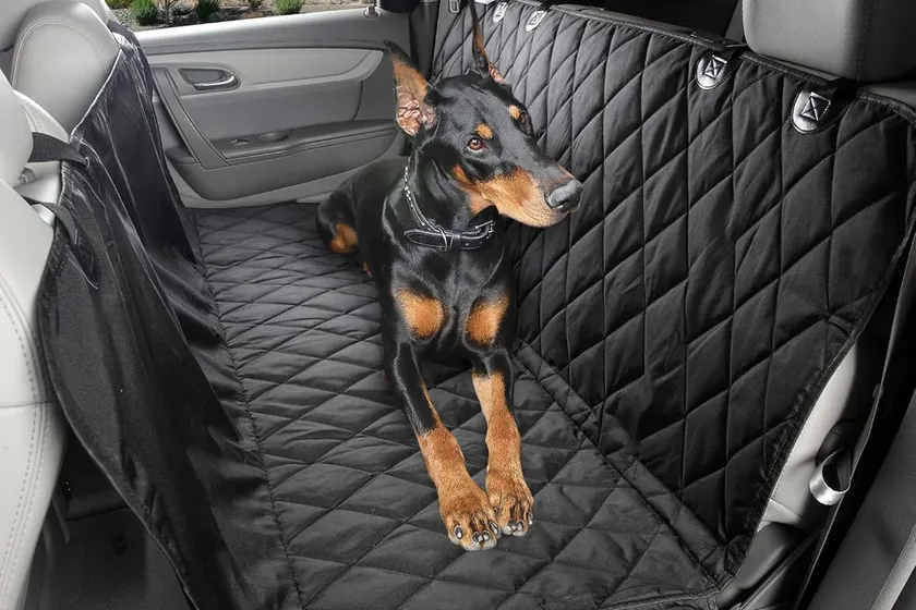 4Knines black waterproof dog backseat hammock cover with nylon clips installed in a truck rear seat