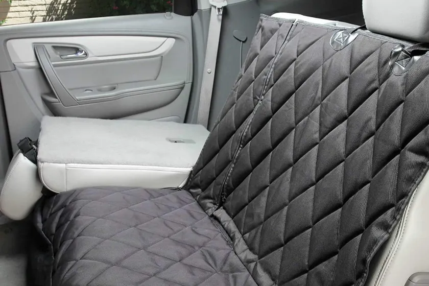 4Knines quilted dog hammock rear seat cover in black shown installed across a vehicle back seat