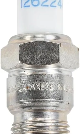 One ACDelco 41-114 iridium spark plug lying on a workbench in front of its ACDelco GM Original Equipment carton