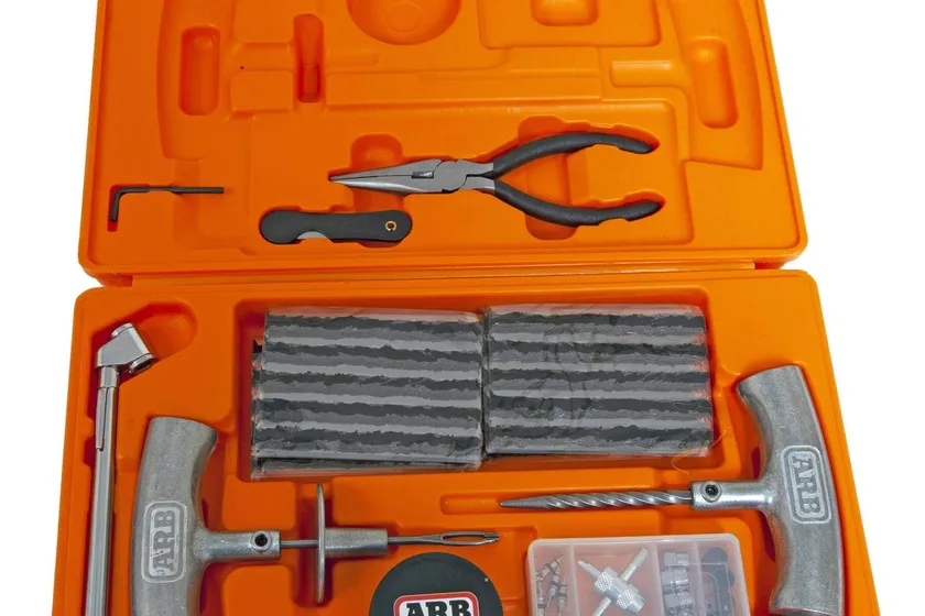 ARB Speedy Seal 2 tire repair kit in its high visibility orange case with steel reamer, insertion needle, pliers and repair cords
