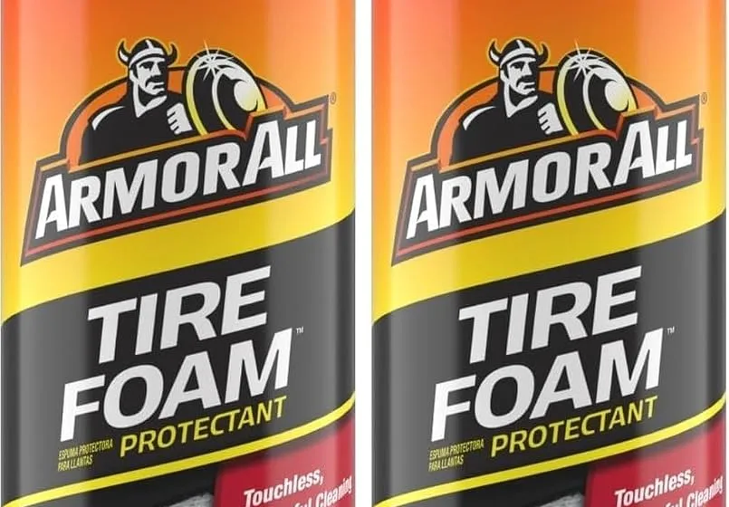 Two Armor All Tire Foam 20 oz aerosol cans next to a freshly cleaned tire and wheel