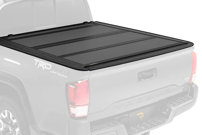 BAK BAKFlip MX4 hard folding tonneau cover with matte black aluminum panels shown on a Toyota Tacoma bed