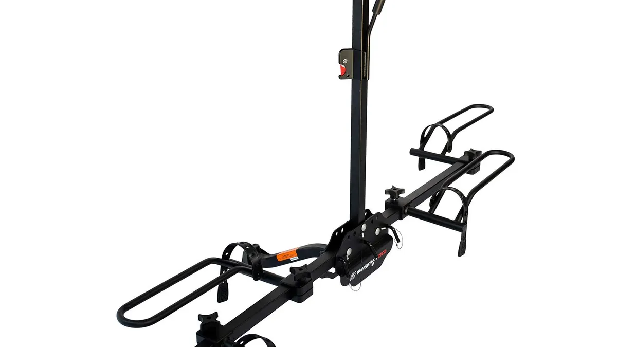 Black steel platform hitch bike rack with two wheel trays mounted in a vehicle receiver