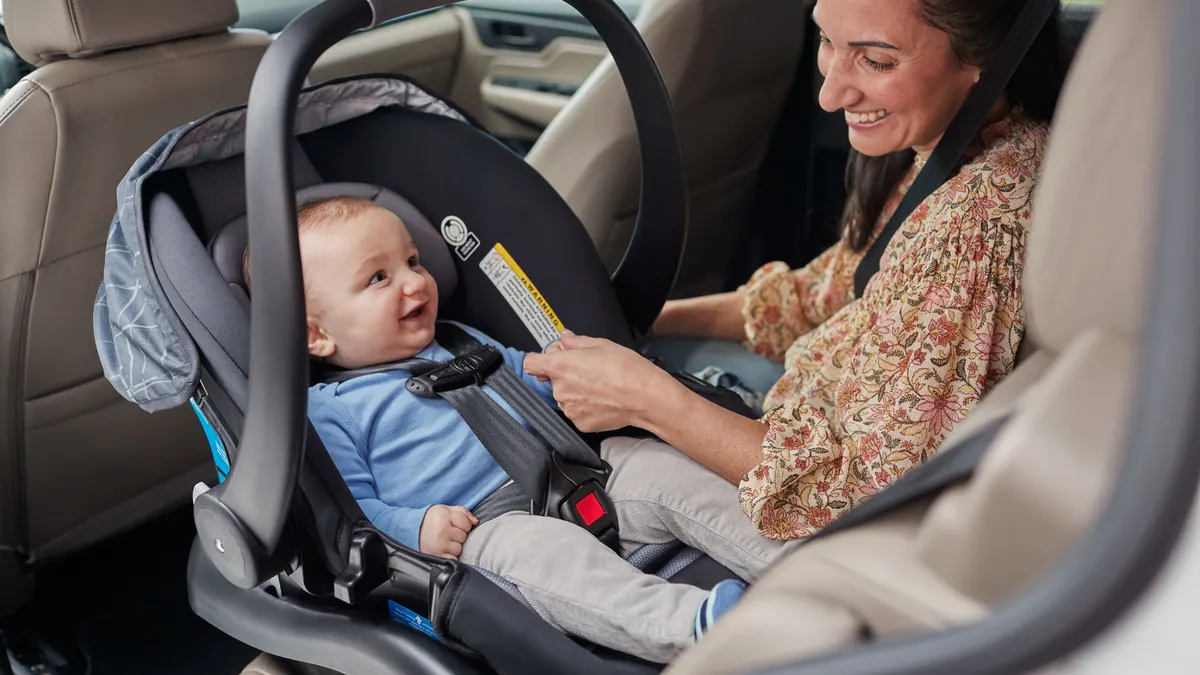 Infant car seat installed in a vehicle back seat