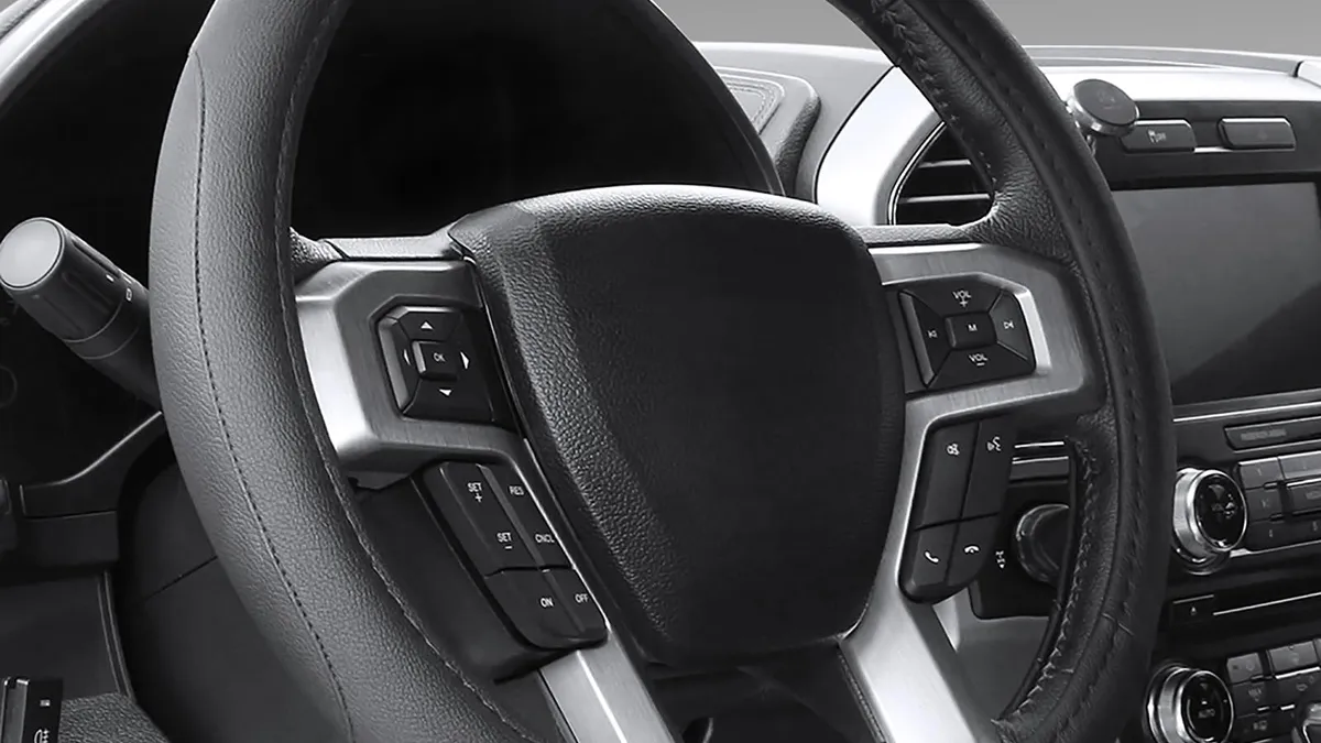 Black microfiber leather steering wheel cover fitted to a car steering wheel