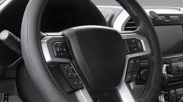Black microfiber leather steering wheel cover fitted to a car steering wheel