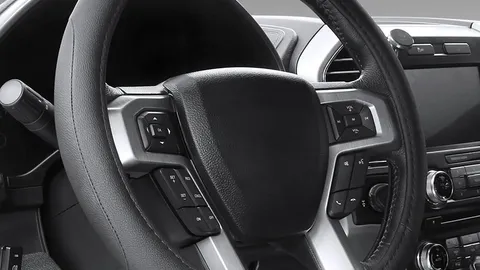 Black microfiber leather steering wheel cover fitted to a car steering wheel