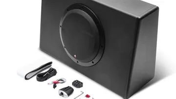 Slim sealed powered subwoofer enclosure sized to fit behind a pickup truck seat