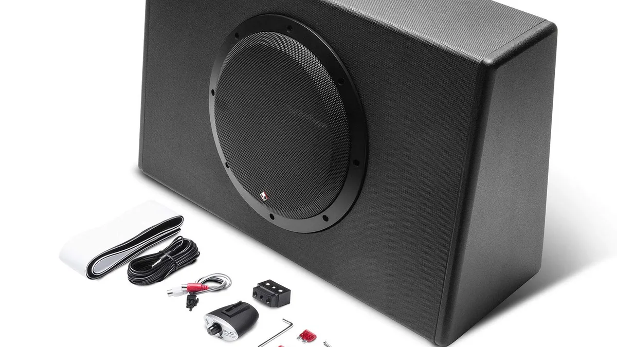 Slim sealed powered subwoofer enclosure sized to fit behind a pickup truck seat