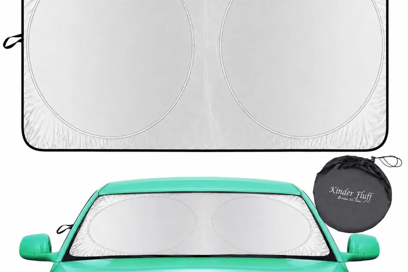 Kinder Fluff single-panel pop-open windshield sun shade with silver reflective face shown covering a car windshield