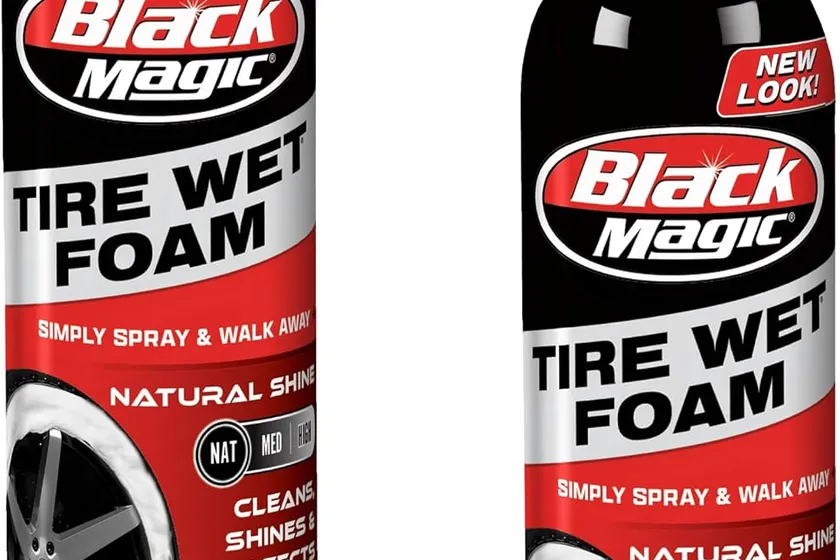 Two Black Magic Tire Wet Foam 18 oz aerosol cans beside a wet-look black tire