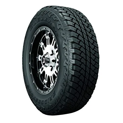 Bridgestone Dueler A/T RH-S all season all terrain tire standing upright, showing its moderate tread blocks, circumferential grooves and black sidewall