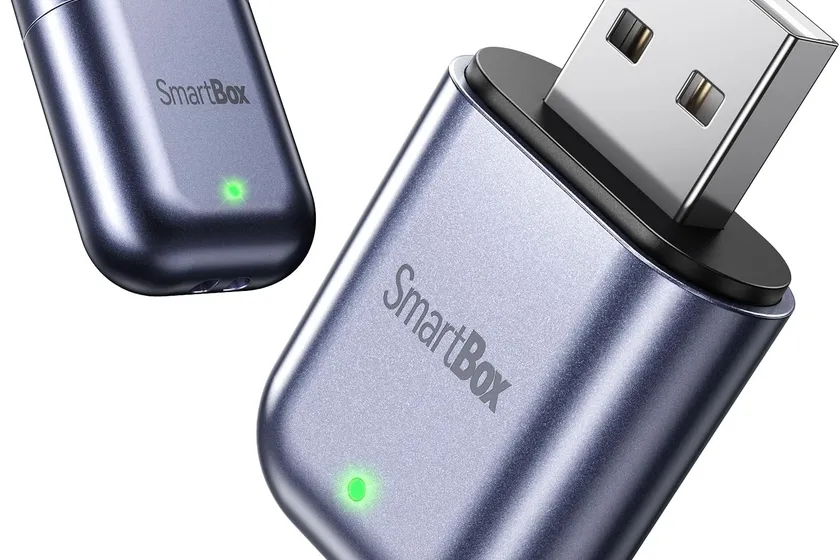 Burnt Sugar ultra-mini wireless CarPlay adapter in Jet Gray plugged into a car USB port