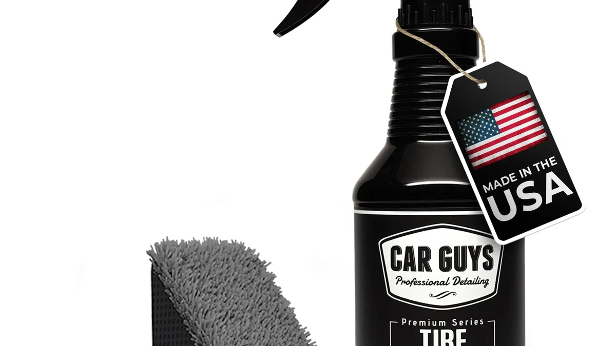 CAR GUYS tire shine spray bottle and foam applicator pad beside a clean black tire