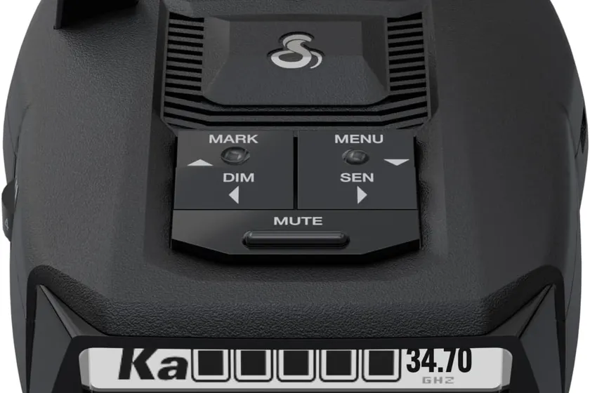 Cobra RAD 490i compact radar detector on its adhesive windshield bracket with USB-C cable