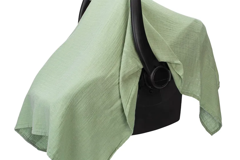 Comfy Cubs sage bamboo rayon and muslin cotton infant car seat cover draped over a baby carrier