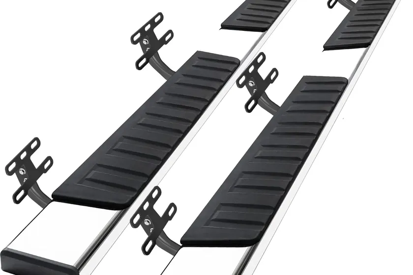 COMNOVA 6 inch polished stainless steel running boards with black step pads on a Ram 1500 crew cab