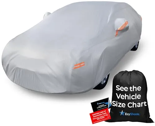 EzyShade size A4 waterproof car cover in reflective grey fitted over a sedan with its strap buckles and mirror pockets visible