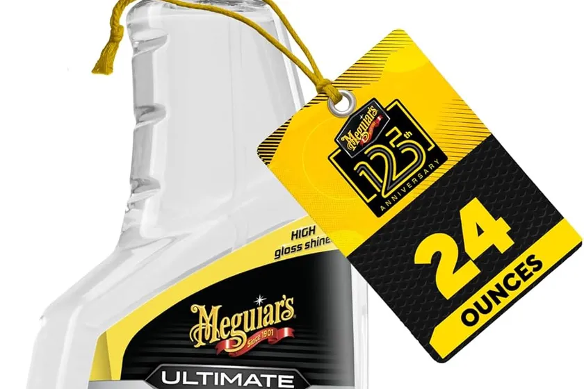 Meguiar's Ultimate Insane Shine Tire Spray 16 oz trigger bottle standing in front of a glossy black tire
