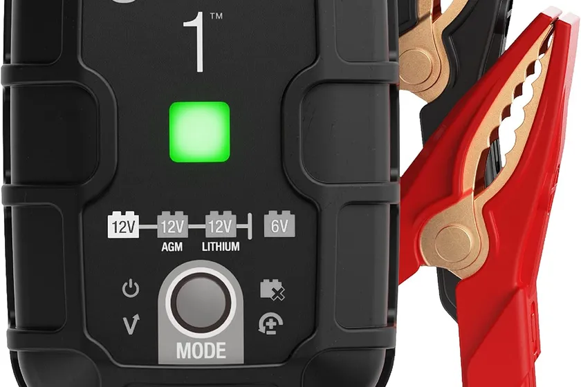 NOCO GENIUS1 black wall plug-in battery maintainer with its DC cable and battery clamps