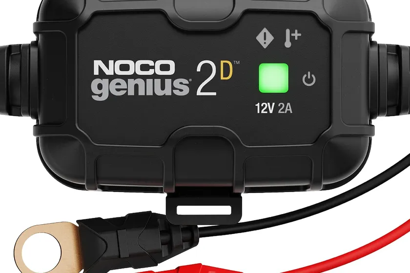 NOCO GENIUS2D black onboard 2A battery maintainer on its snap-fit mounting bracket with eyelet terminal cable