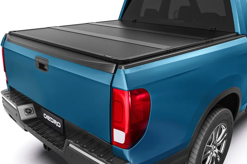 OEDRO FRP hard tri-fold tonneau cover with textured black fiberglass panels on a Honda Ridgeline bed