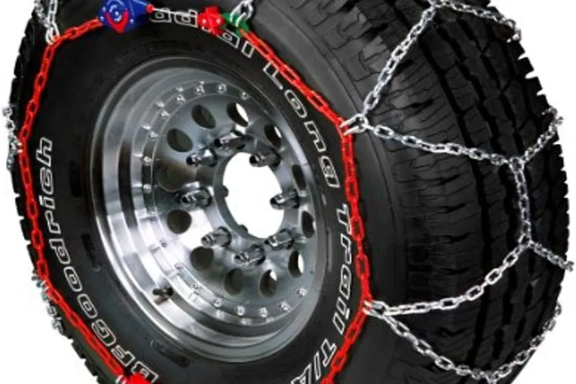 Silver SCC Auto-Trac 0232805 diamond pattern tire traction chain coiled with its self-tightening ratchet ends visible