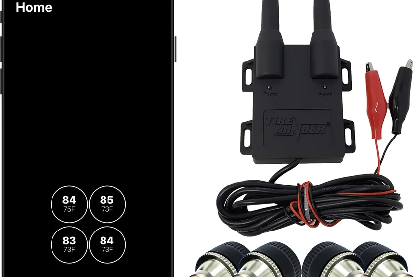 TireMinder Smart TPMS signal booster with four cap transmitters and the smartphone app showing tire pressure readings