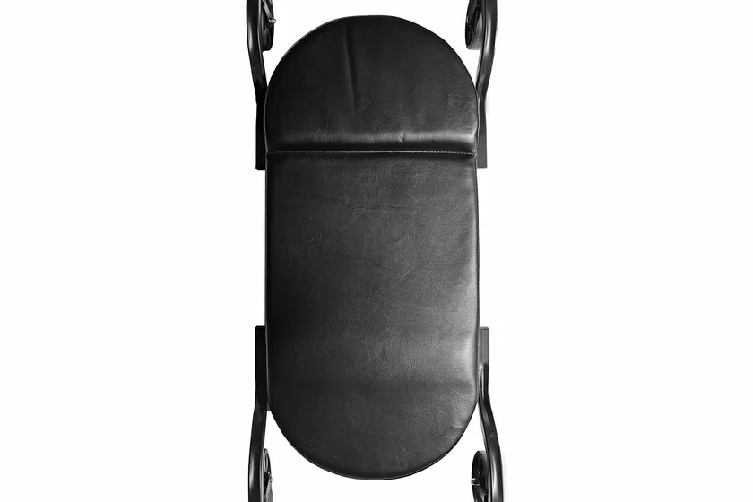 Black Traxion 1-100 ProGear wide body creeper with padded contoured deck and large five inch all-terrain casters