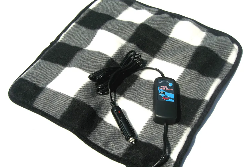 Black and white plaid Trillium Car Cozy 2 twelve volt heated travel pad laid on a car seat