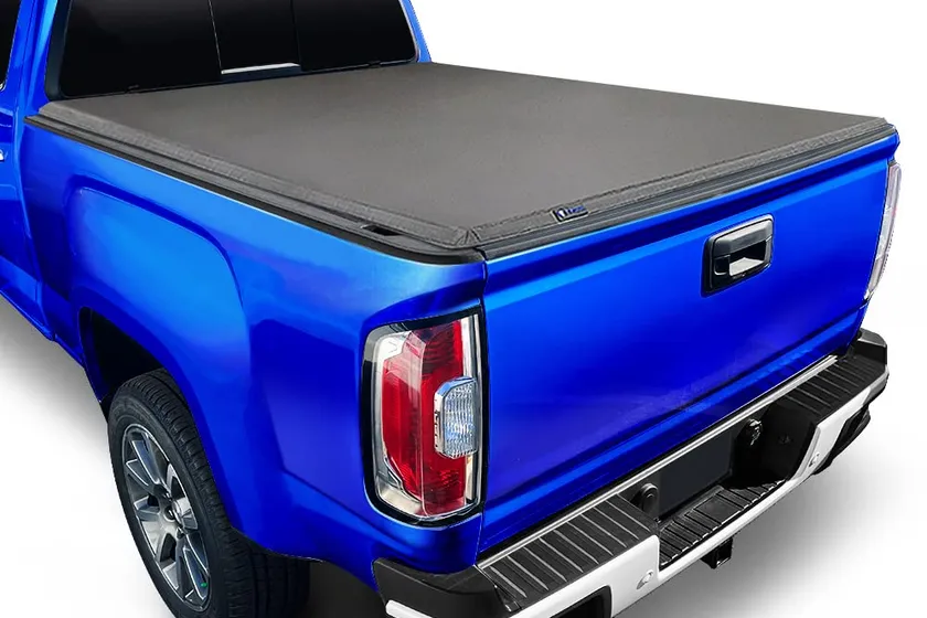 Tyger Auto T3 soft tri-fold tonneau cover folded on the bed of a 2023-2026 Chevy Colorado
