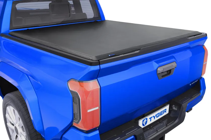 Tyger Auto T1 soft roll-up tonneau cover with black vinyl shown closed on a Toyota Tacoma bed