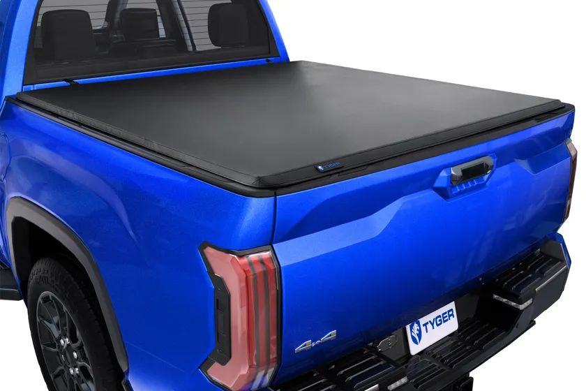 Tyger Auto T3 soft tri-fold tonneau cover in black vinyl folded partway open on a Toyota Tundra bed