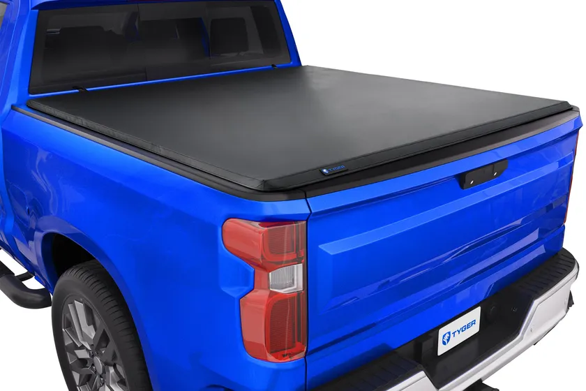 Tyger Auto T3 soft tri-fold tonneau cover shown closed and partially folded on a truck bed