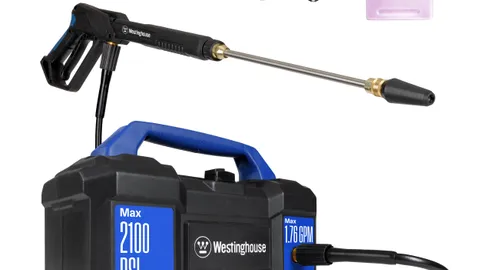Compact electric pressure washer with a foam cannon set up for washing a car in a driveway