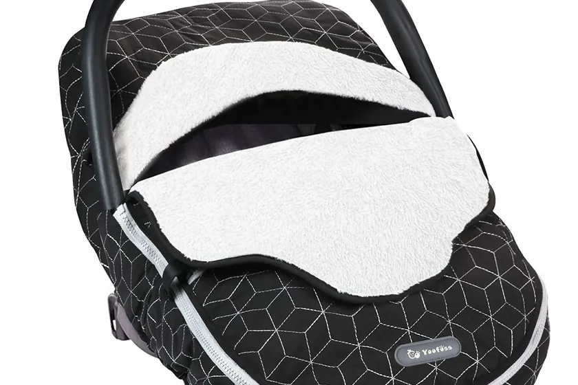 Yoofoss black plush fleece winter car seat canopy draped over an infant carrier